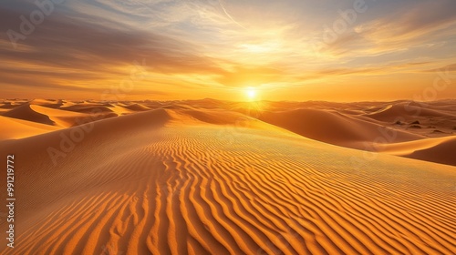 Golden sand dunes stretch across the horizon illuminated by warm sunlight at sunset evoking a serene and vast desert ambiance