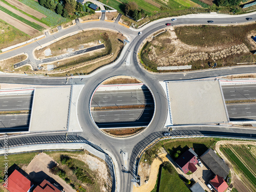 Krakow, Poland. Batowice highway junction in construction on S53. part of motorway freeway around Cracow. Traffic circle with a hole inside, viaducts, tunnels and ramps. September 2024. Aerial view photo