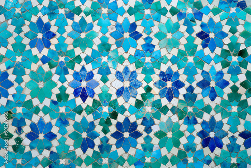  Moroccan Zellige tilework, featuring complex star-shaped and interlaced geometric designs in shades of blue, green, and white, arranged in a mesmerizing, repeating mosaic pattern