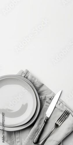 Classic white ceramic plate with a fork and knife on a linen tablecloth, viewed from above. Perfect for cafe menus, kitchen decor, or elegant dining presentations.