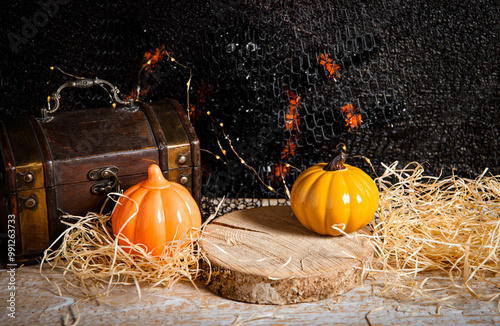 Halloween autumn products background set. Ceramic pumpkins, wooden disc, spider, treasure box, studio shot. photo