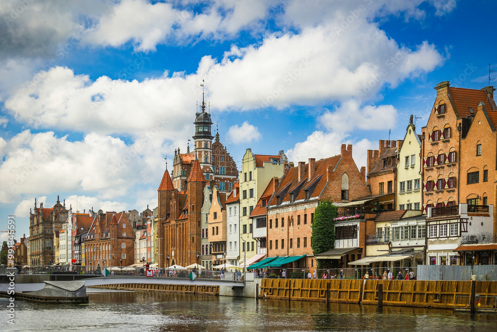 Obraz premium Beautiful city of Gdansk in the margins of the Motlawa river with the touristic boats and coloured buildings