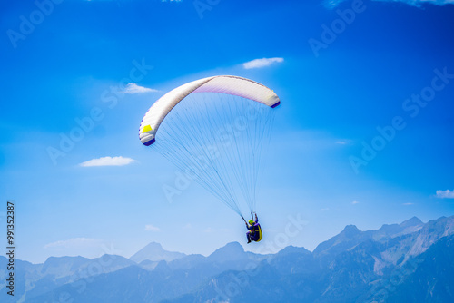 Paragliding in the sky. Paraglider flying over Landscape sun set Concept of extreme sport, taking adventure challenge.