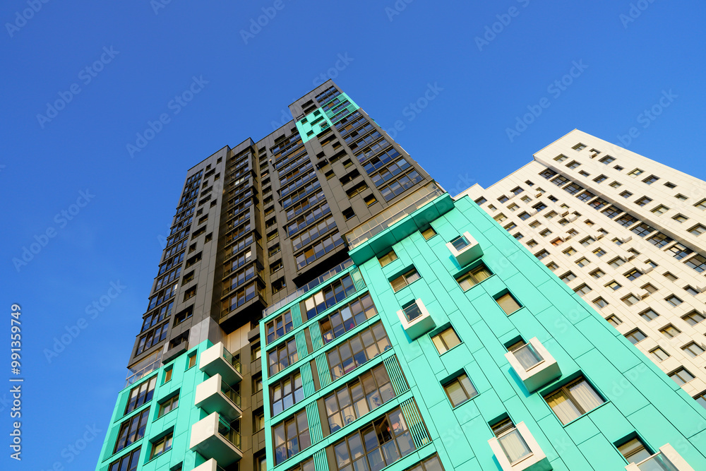 Modern colourful building on blue sky. Skyscraper facade. Modern High rise residential facade. Windows of Skyscraper. Architecture building exterior, window house block. High Rise house background. Modern colourful building on blue sky. Skyscraper facade. Modern High rise residential facade. Windows of Skyscraper. Architecture building exterior, window house block. High Rise house background.