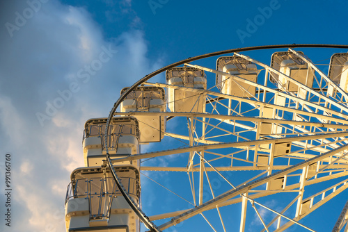 Ferris wheel against the sky with clouds, illuminated by the rays of the setting sun, Crikvenica, Croatia. High quality photo photo