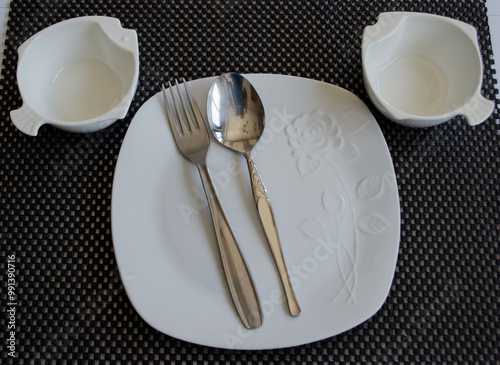 empty plate and cutlery set on a table