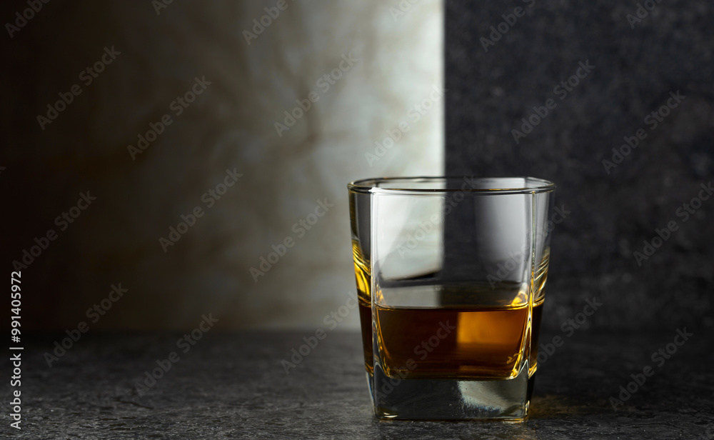 Glass of whiskey on a black table. Glass of whiskey on a black table.