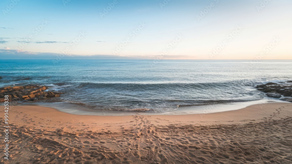 Obraz premium View of a Beach with Footprints in the Sand