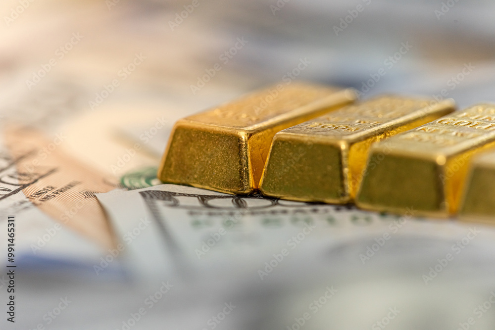 Finance investment concept of gold bars on the 100 US dollars banknote background Finance investment concept of gold bars on the 100 US dollars banknote background