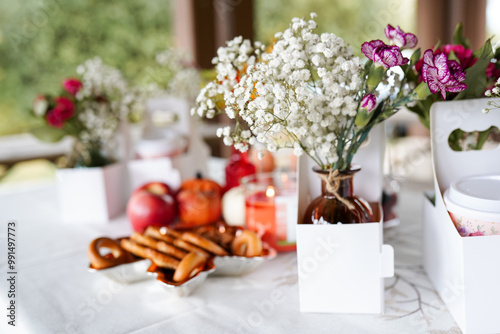 a beautifully set table outdoors, featuring small vases of delic photo