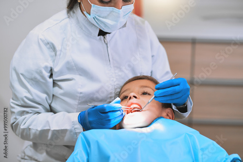 Photography Checkup, dentist and examination with child in hospital for procedure or consultation in oral care clinic