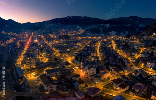 Night aerial photo of a city in the mountains
