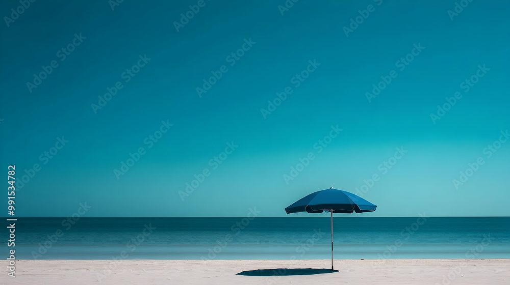 Fototapeta premium A tranquil blue beach umbrella stands against a clear sky, embodying a minimalist coastal vibe.