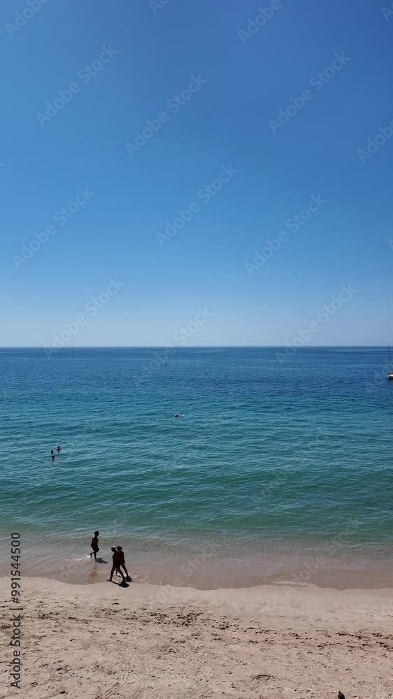 Sesimbra Beach in Portugal filled with tourists during summer, enjoying the sun and sea on a lively vacation day.
Sesimbra Beach in Portugal filled with tourists during summer, enjoying the sun and sea on a lively vacation day.