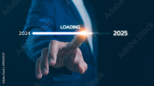 Obraz na płótnie Businessman touch on loading progress from 2024 to 2025, Planning and challenge strategy in new year 2025 Concept. New business startup in 2024. New year 2025 loading, calendar date, end of the year. w salonie