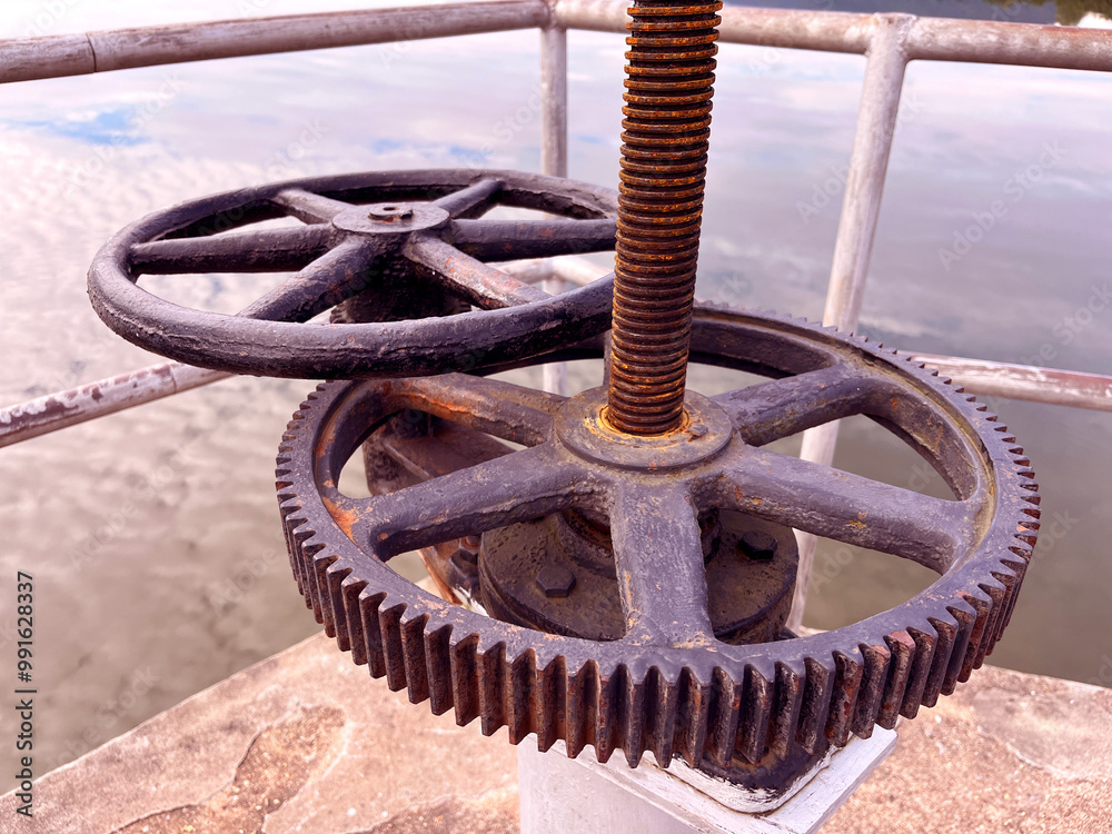 rusted industrial gears and a turning mechanism, highlighting the texture and wear of aged metal, The machinery, set against a muted background, mechanical engineering rusted industrial gears and a turning mechanism, highlighting the texture and wear of aged metal, The machinery, set against a muted background, mechanical engineering