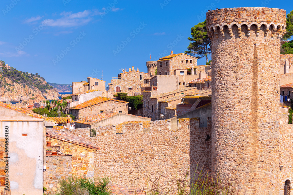 Old fortified wall, towers and stone houses inside in Tossa de Mar, Catalonia, Spain Old fortified wall, towers and stone houses inside in Tossa de Mar, Catalonia, Spain