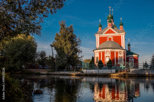 The Golden Ring of Russia, the city of Pereslavl-Zalessky. The Church of the Forty Martyrs of Sebaste is reflected at dawn in Pleshcheyev Lake. photo