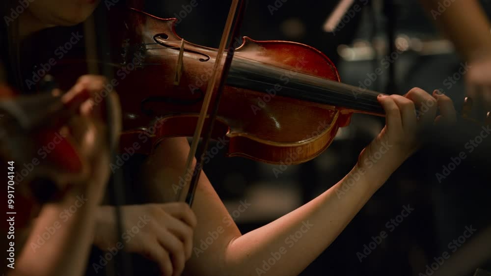 Footage of the violin section in a classical jazz orchestra — Female violinist.