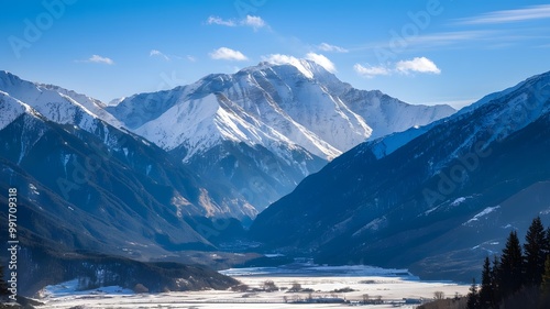 Majestic Snow-Capped Mountains Under Bright Blue Winter Sky with Snowy Valley