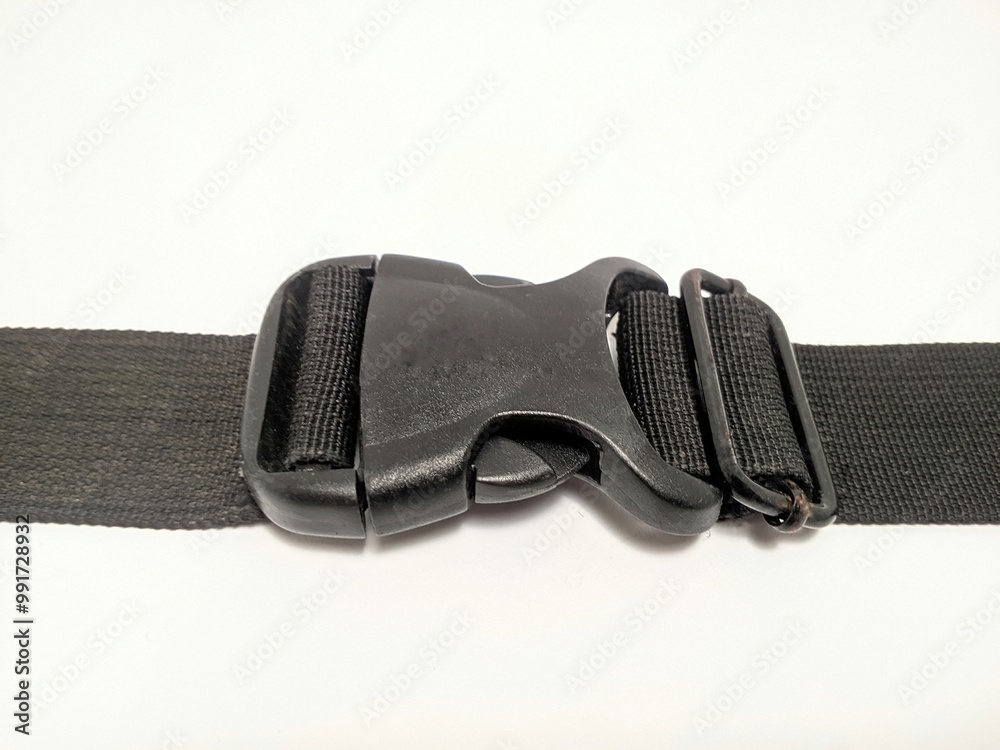 Black sling bag strap with plastic hook on white background. Black sling bag strap with plastic hook on white background.