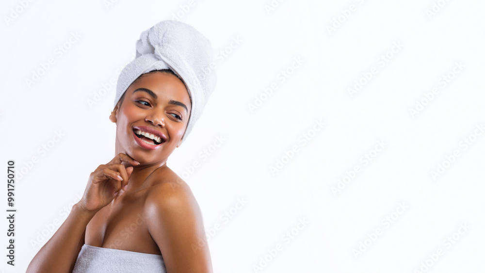 Cheerful black girl wrapped in towels just after shower looking at free space, panorama Cheerful black girl wrapped in towels just after shower looking at free space, panorama