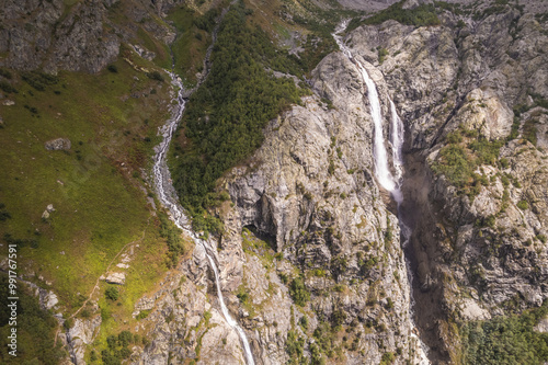 Shdugra Waterfall on rocky cliff. photo