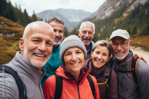Group portrait of senior friends enjoying hiking in mountains