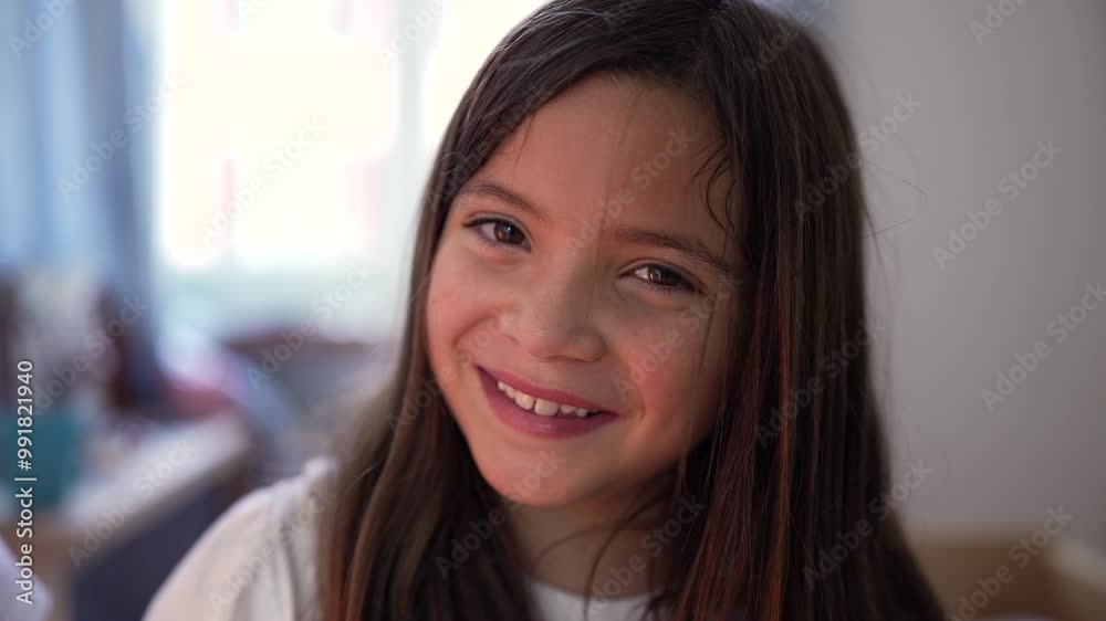 Portrait of young girl smiling at the camera, showing happiness and innocence in a home setting, with natural expression Portrait of young girl smiling at the camera, showing happiness and innocence in a home setting, with natural expression