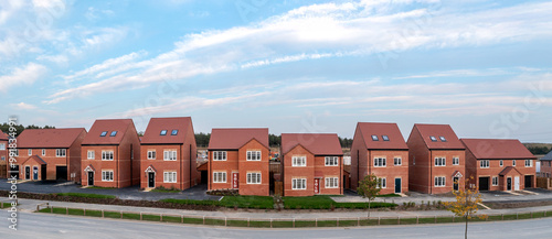 Panorama of a row of new build homes with sold sign
