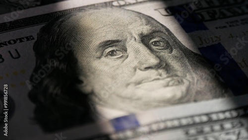 Close-up of a 100 dollar bill. The face of Benjamin Franklin. Macro photo