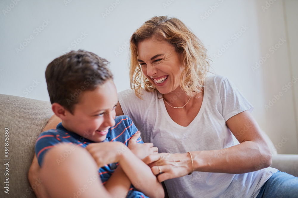Happy mother, laughing and playing with son on sofa for bonding, holiday or fun weekend together at home. Mom, child or kid with smile or laughter for playful childhood, love or support at house Happy mother, laughing and playing with son on sofa for bonding, holiday or fun weekend together at home. Mom, child or kid with smile or laughter for playful childhood, love or support at house