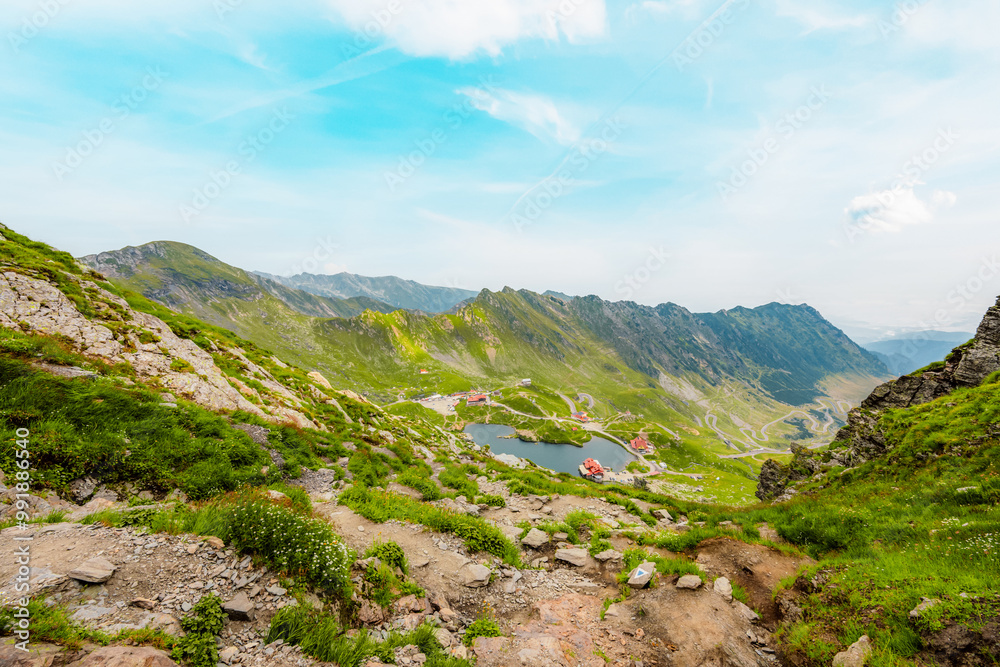 Hiking in Fagaras mountains on Iezerul Caprei peak over Transfagarasan serpentine road carpathian mountains. Mountains landscape. Balea lake Hiking in Fagaras mountains on Iezerul Caprei peak over Transfagarasan serpentine road carpathian mountains. Mountains landscape. Balea lake