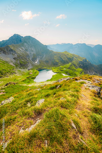 Hiking in Fagaras mountains on Iezerul Caprei peak over Transfagarasan serpentine road carpathian mountains. Mountains landscape. Lake capra photo