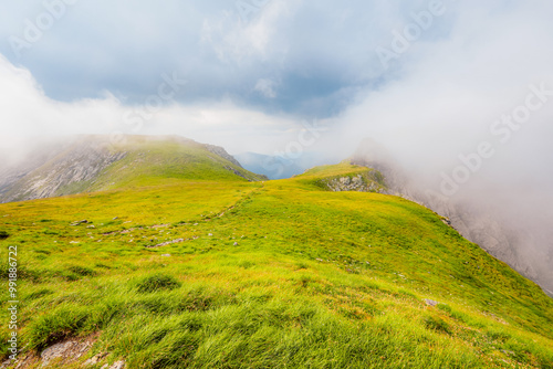 Hiking in Fagaras mountains on Iezerul Caprei peak over Transfagarasan serpentine road carpathian mountains. Mountains landscape photo