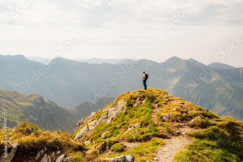 Hiking in Fagaras mountains on Iezerul Caprei peak over Transfagarasan serpentine road carpathian mountains. Mountains landscape