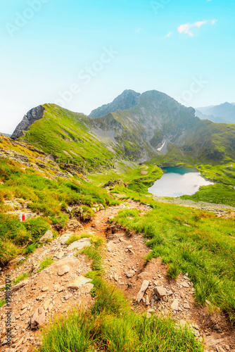 Hiking in Fagaras mountains on Iezerul Caprei peak over Transfagarasan serpentine road carpathian mountains. Mountains landscape. Lake capra photo