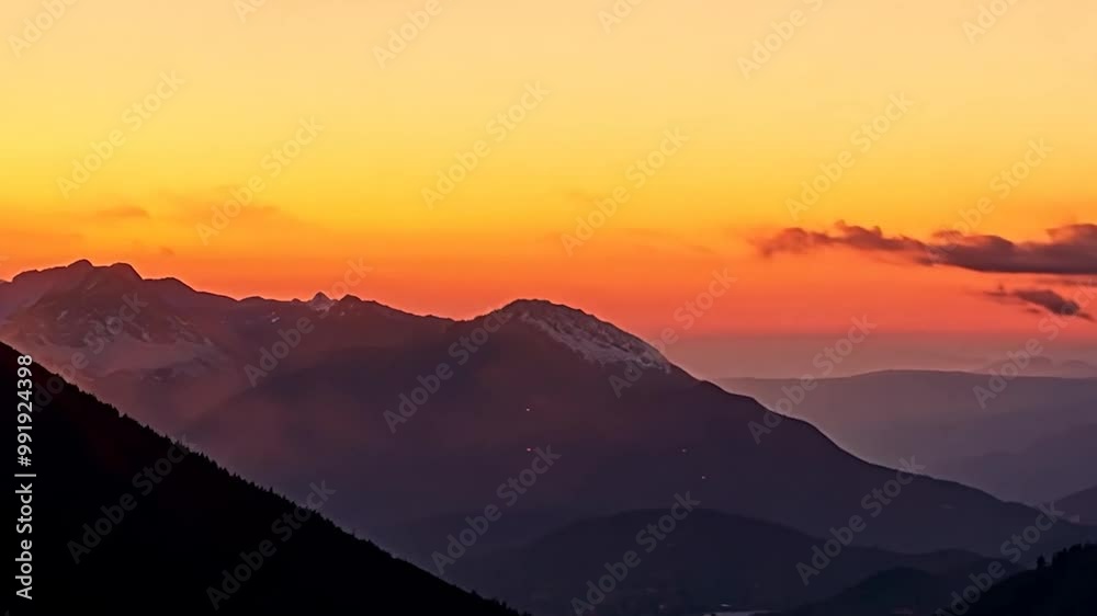 As the sun sets, vibrant colors fill the sky above the mountain range, casting elongated shadows and creating a serene atmosphere in nature As the sun sets, vibrant colors fill the sky above the mountain range, casting elongated shadows and creating a serene atmosphere in nature