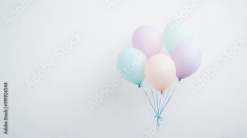 pastel-colored balloons floating against white background, with copy space for text