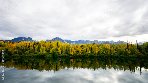 In Alaska, fall is putting its color on almost everything. Travel season is almost closed due to the cold weather. Snow starts to cover the trails. Water reflects foliage colors. 