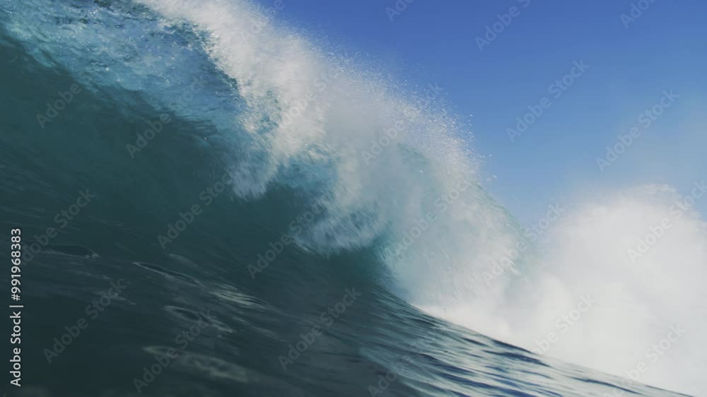 Slow-motion shot of a wave crashing with great intensity, filmed from inside the water at sunrise, showcasing the wave's raw power and motion Slow-motion shot of a wave crashing with great intensity, filmed from inside the water at sunrise, showcasing the wave's raw power and motion