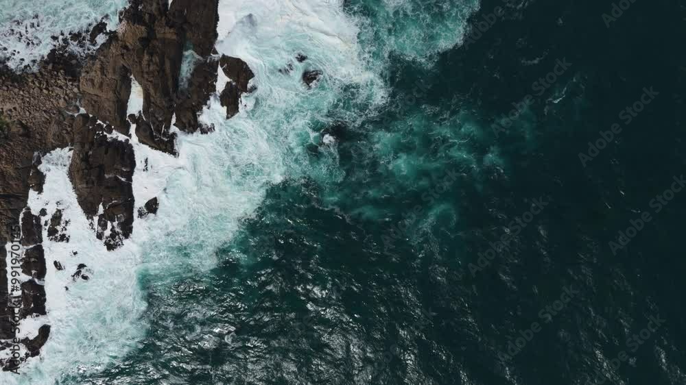 Aerial birds eye view showcasing powerful ocean waves crashing against the rocky coastline at Playa Chica, Quintay in Valparaíso, Chile. Push Forward Shot Aerial birds eye view showcasing powerful ocean waves crashing against the rocky coastline at Playa Chica, Quintay in Valparaíso, Chile. Push Forward Shot