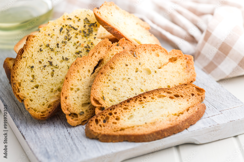 Crispy roasted bruschetta bread on cutting board. Crispy roasted bruschetta bread on cutting board.