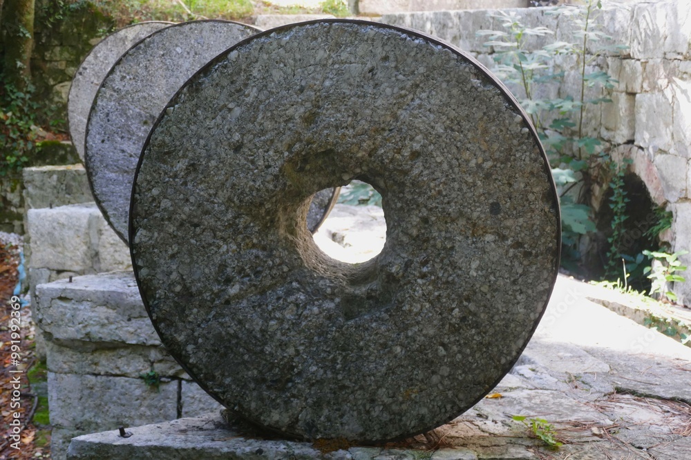 Ancient stone wheels in old mill by in rural countryside Ancient stone wheels in old mill by in rural countryside