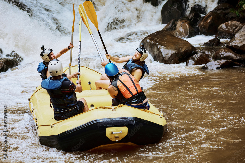 Obraz premium River, men and celebration with paddle for rafting, challenge and winner for competition in water sports. Achievement, friends and safety helmet with inflatable boat for success, support and teamwork