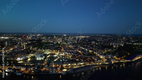 Wallpaper Mural High Angle Night Footage of Illuminated Portsmouth Central City and Docks on Ocean Edge at Just After Sunset Time. England United Kingdom. May 15th, 2024 Torontodigital.ca
