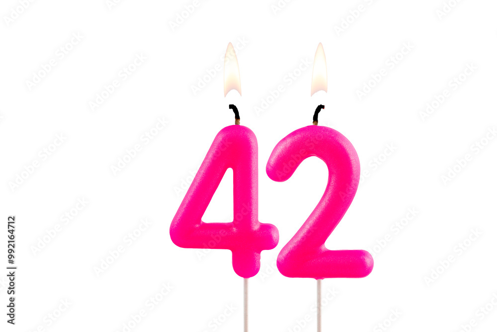 Pink number 42 birthday candle on white background