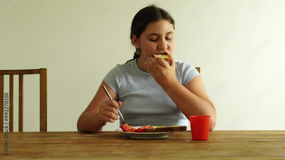 Teenager girl has breakfast Teenager girl has breakfast