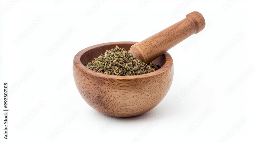 A wooden bowl with herbs and a wooden pestle A wooden bowl with herbs and a wooden pestle