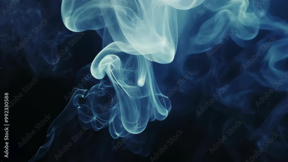 Blue smoke swirls against a black background Blue smoke swirls against a black background